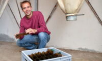 Scientist Emanuel Heitlinger with the mouse traps he uses for his research on farms (photo by Patrick Pleul, dpa)